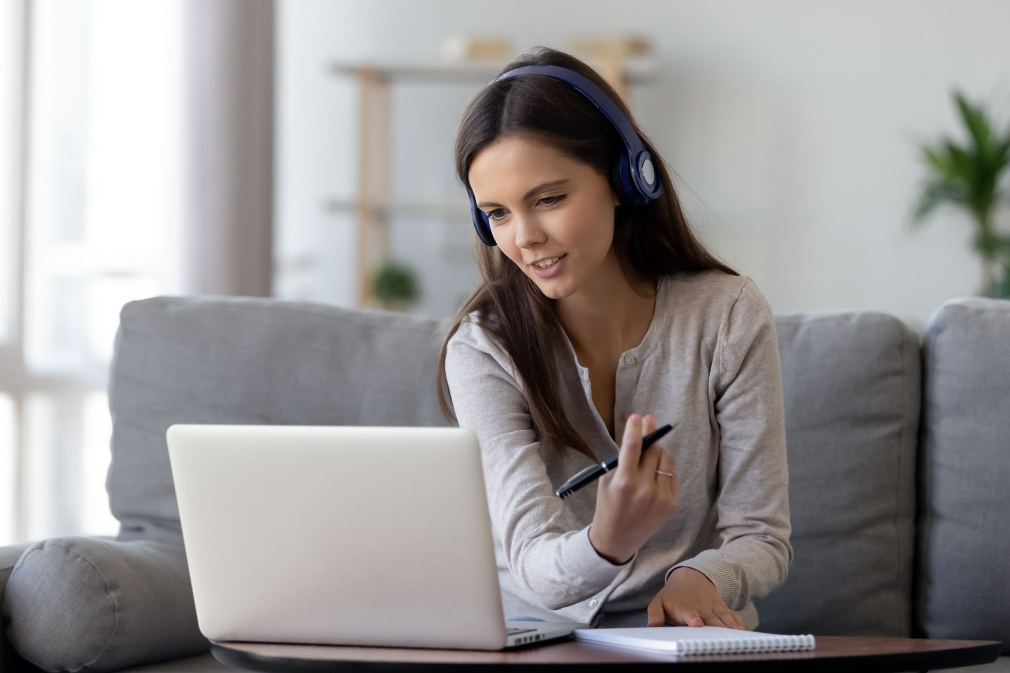 A female student with a laptop attending her online class