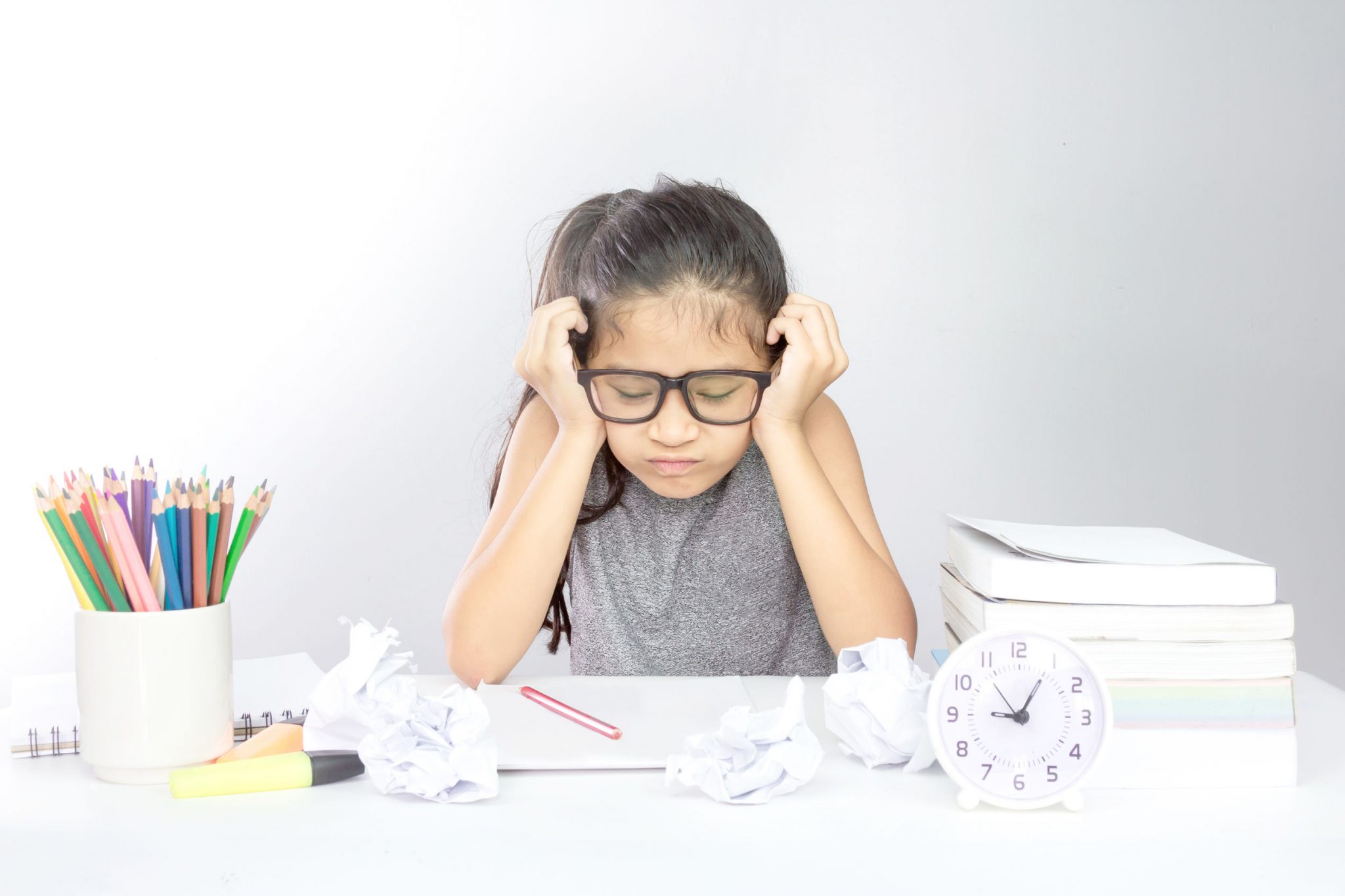 A stressed female student on her table thinking about the study load