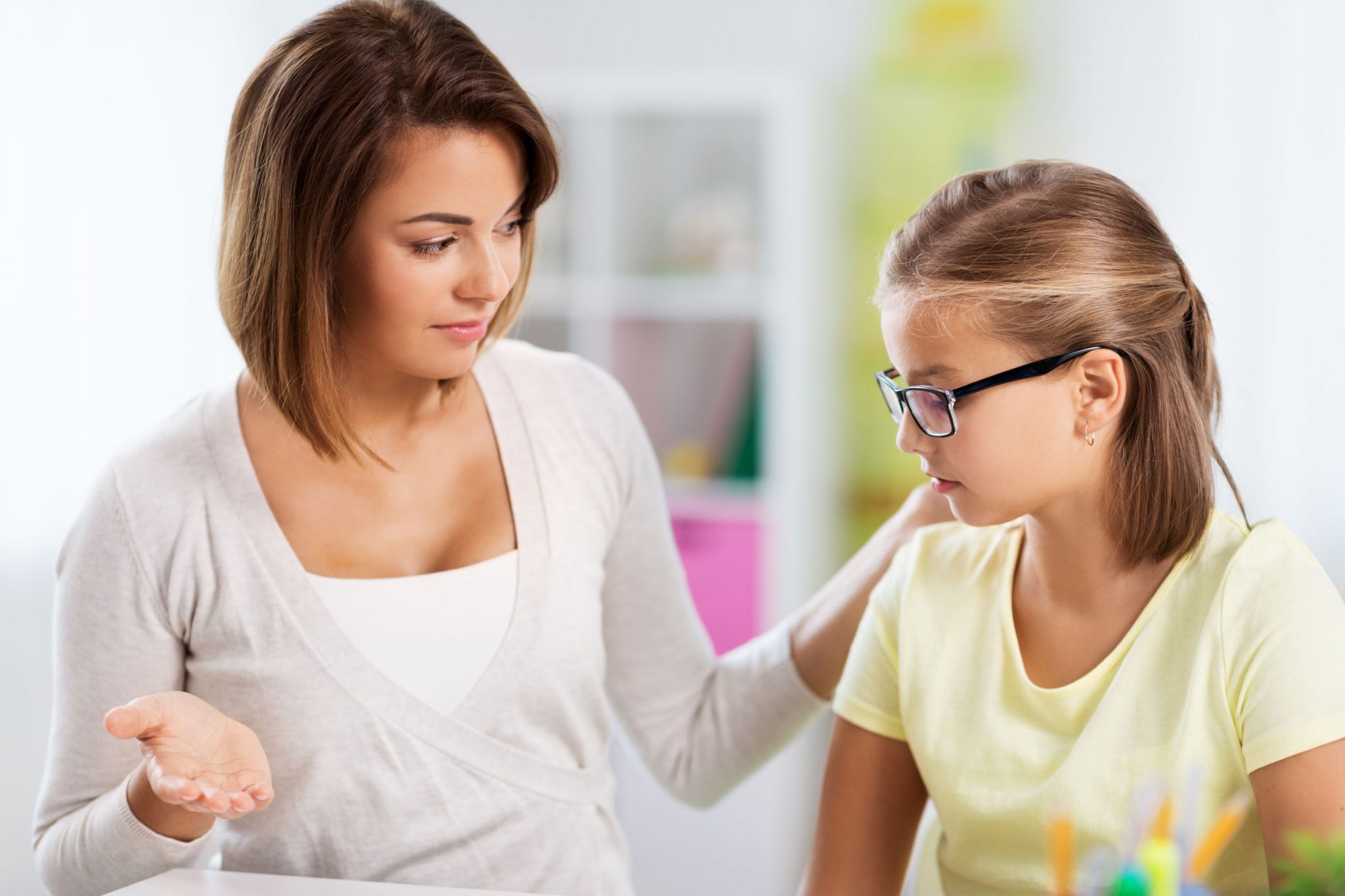 A mother supporting her female child who is stressed about her study