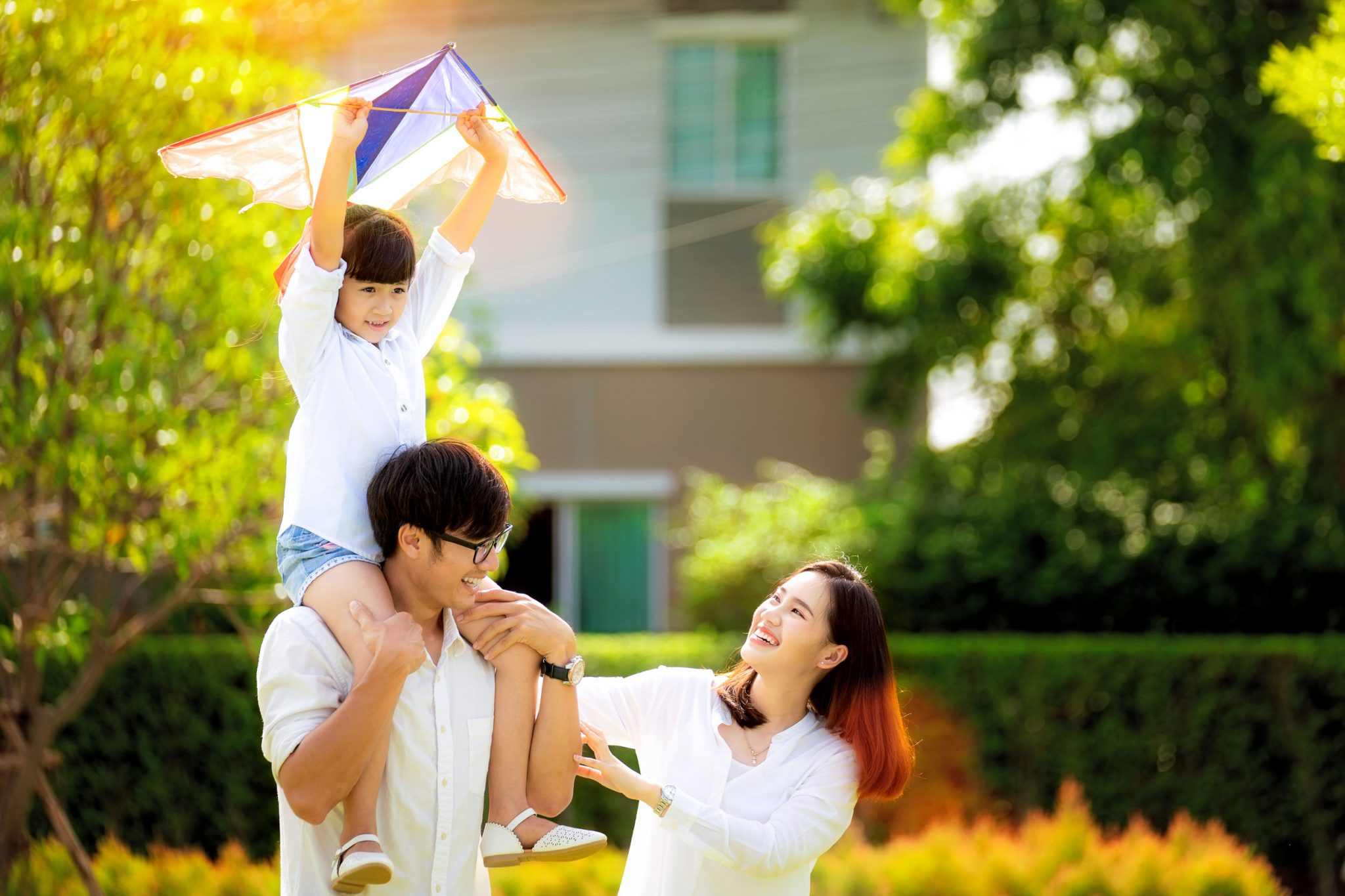 Parents and their child enjoying happy moment in a garden